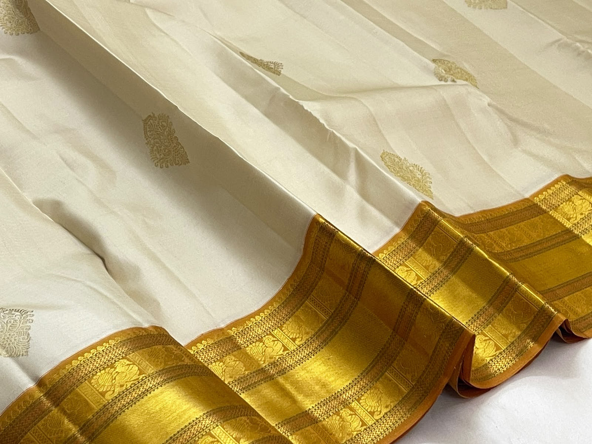 Venpattu Ivory Pure Silk Kanchipuram Butta Saree with Manjal Gold Pettu