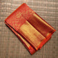 Broad lustrous gold zari border against the Vermilion Coral Red pure silk body.