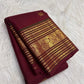 Deep Arakku red Kanjivaram Varisaipet saree with Mayil and Kamalam zari buttas.