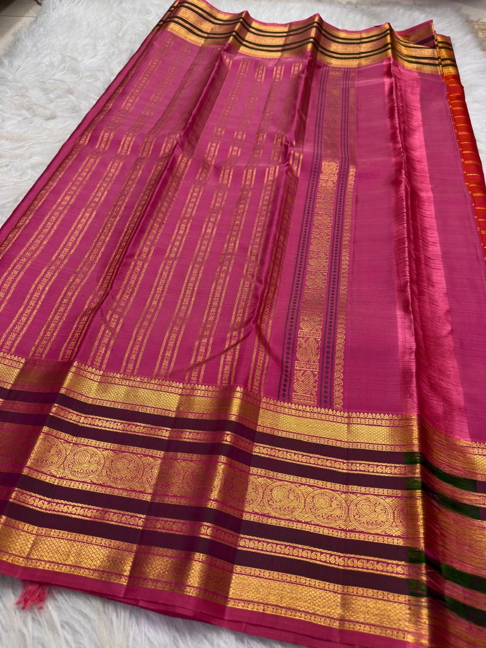 Vermilion Kanjivaram saree with fine gold zari lines.