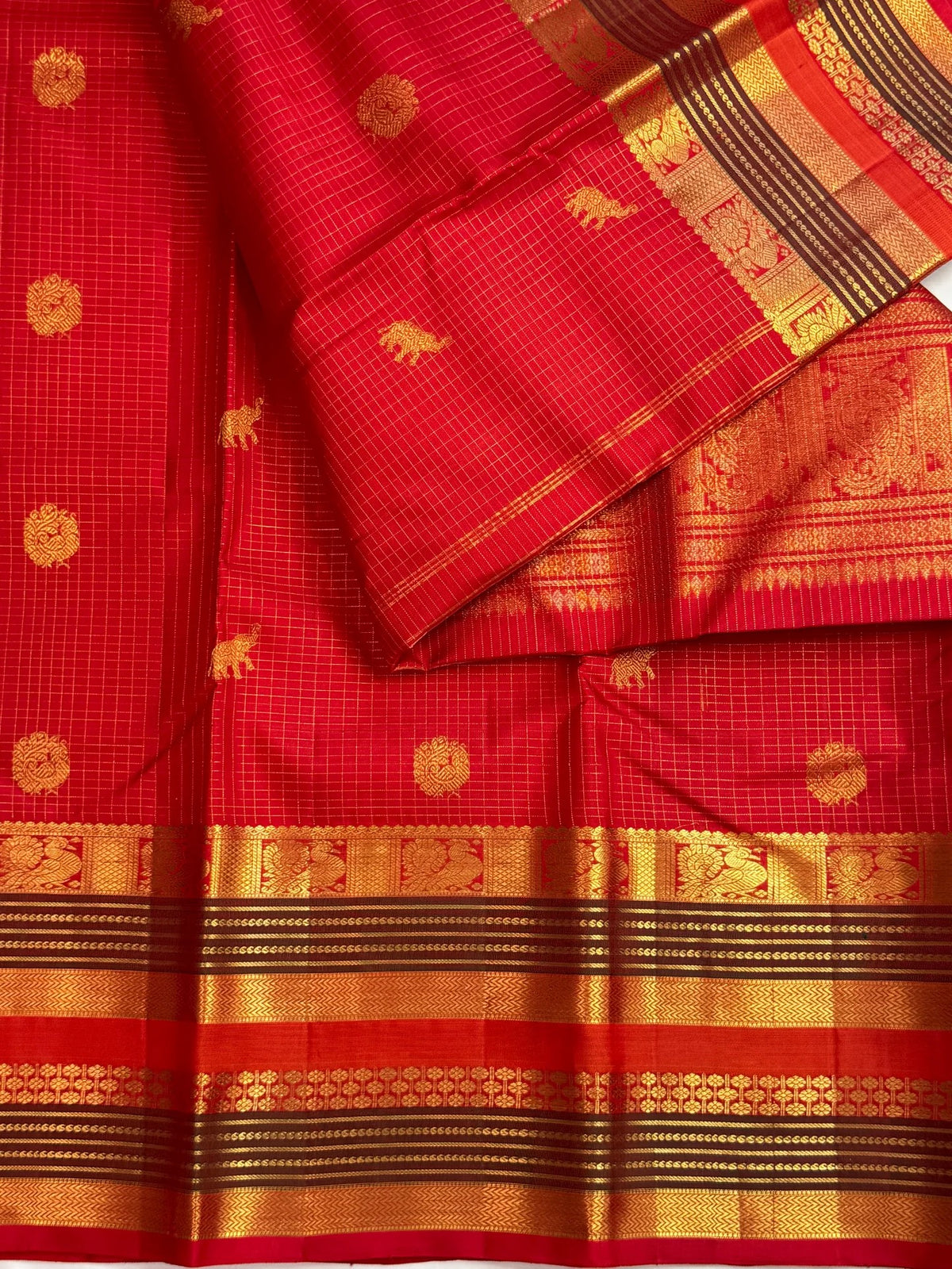 Radiant vermilion red reminiscent of temple kumkum pure silk Kanchipuram saree, red zari kattam fine checks body; traditional Zari Kattam weave.