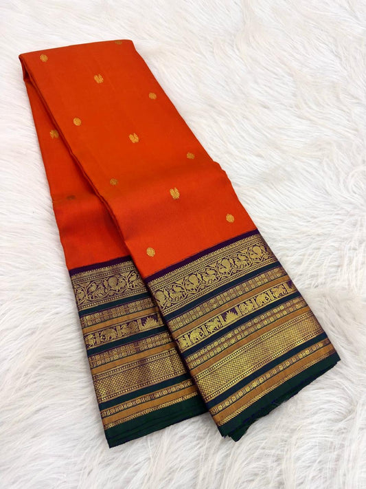 Close-up of vermilion orange pure mulberry silk body with gold zari buttas, Kanchi Pattu Varisaipet saree