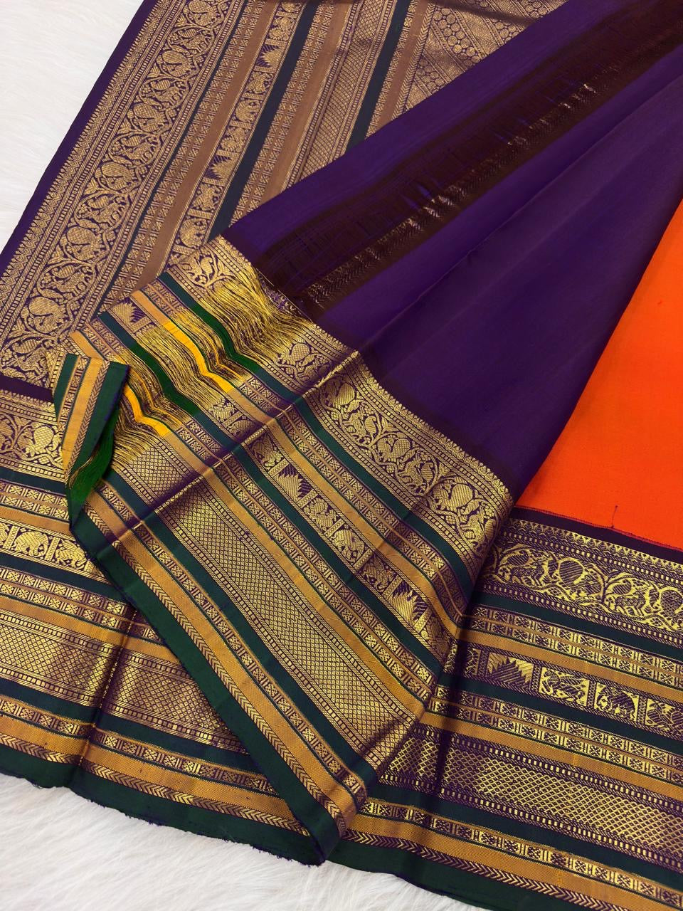 Full drape of Vermilion Orange Kanchi Pattu Varisaipet saree with heritage zari border