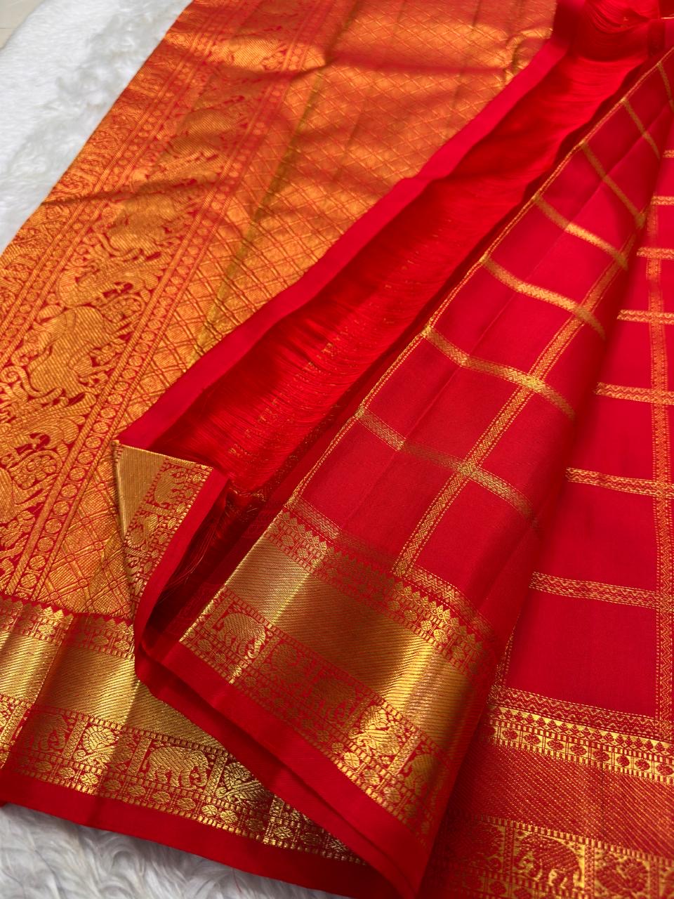Vermilion orange handwoven pure silk KanchiPattu Zari Kattam saree with Mayil Chakram zari motifs, full view