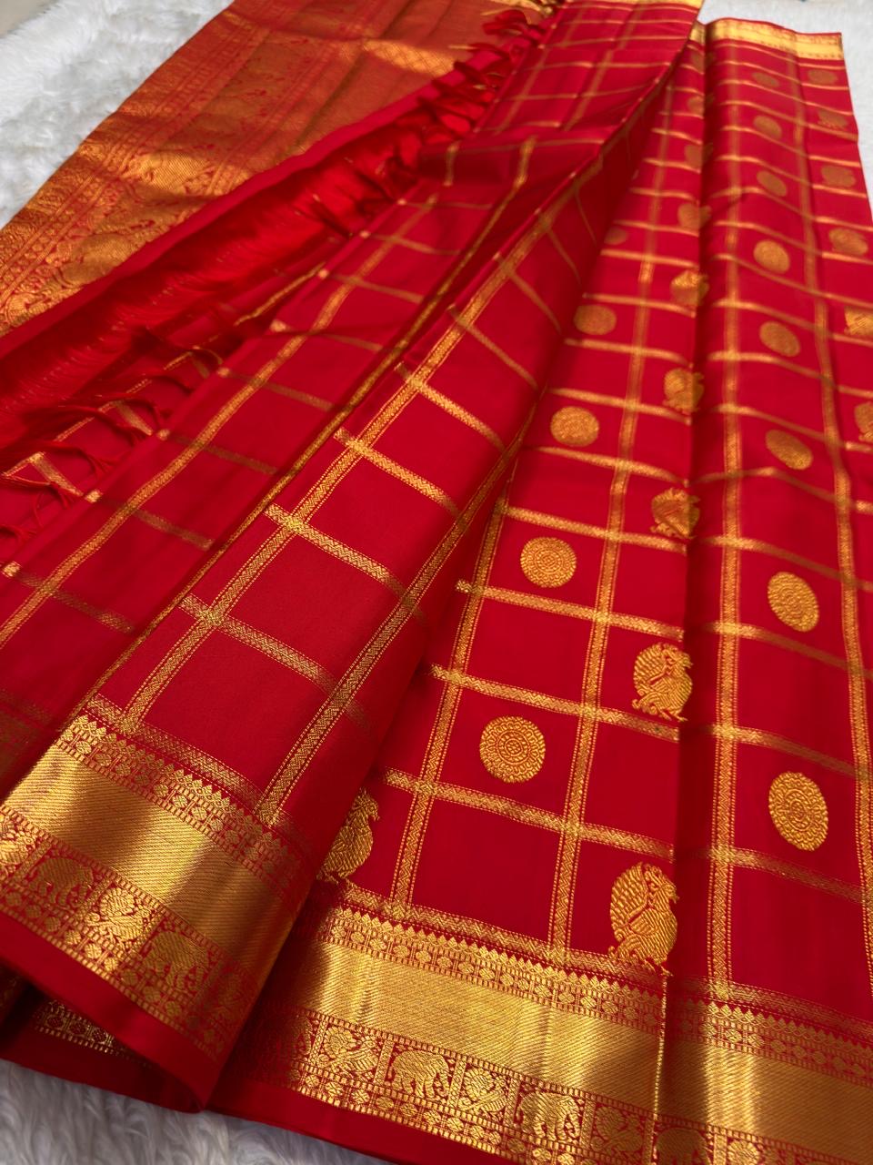 Vermilion orange Zari Kattam Kanchipuram saree with Mayil Chakram, folded view