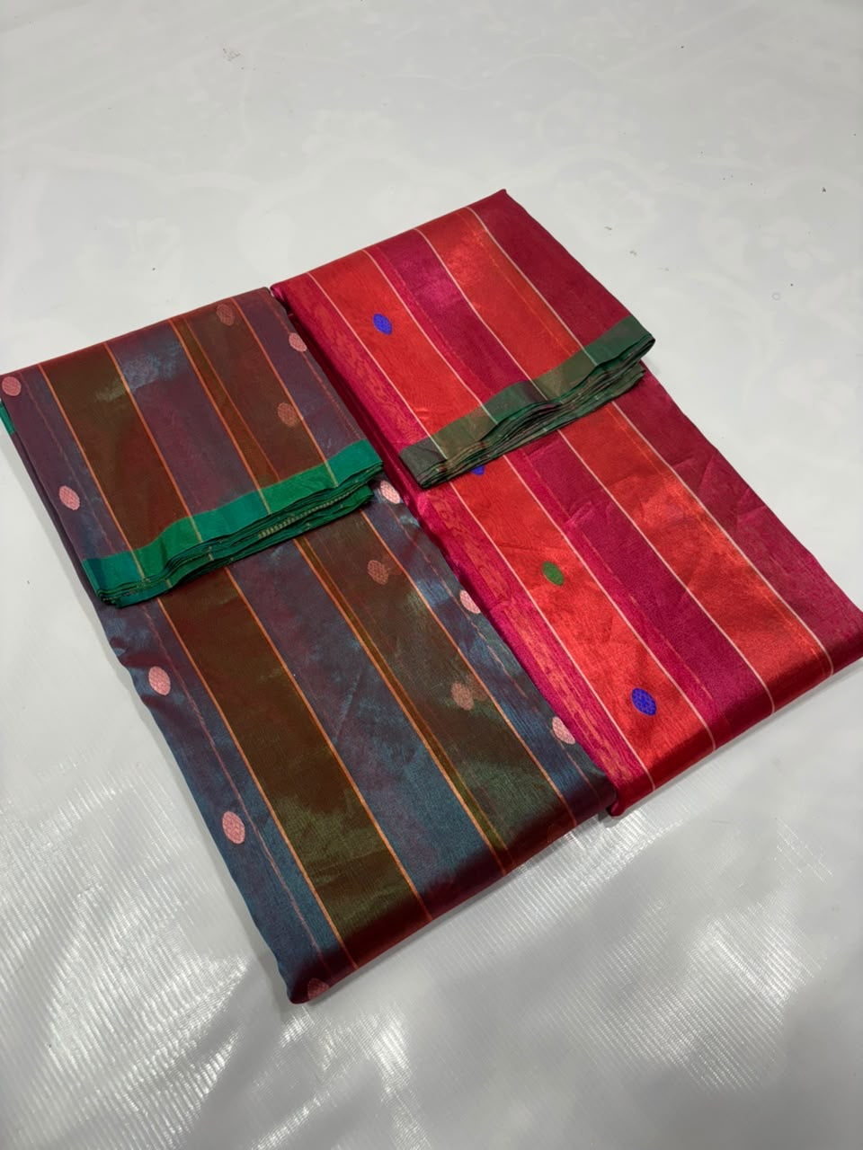 Vermilion Red and Rani Pink Tissue Silk Chanderi saree with fine jari stripes, blue and green buttas and striped pallu