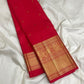 Vermilion Red Kanchipuram Butta saree with broad antique-gold geometric zari border.