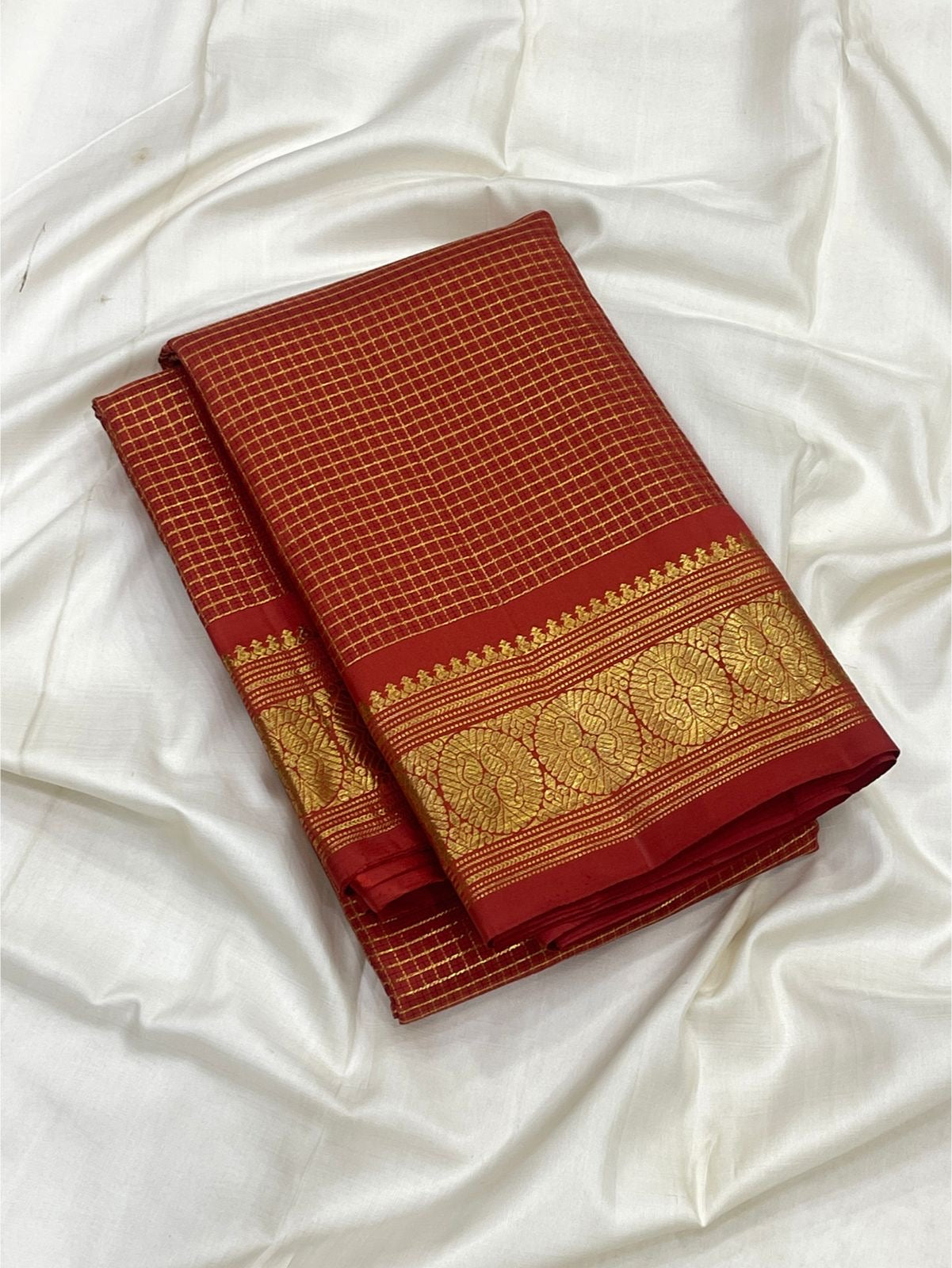 Broad floral gold zari border on Vermilion Red Zari Kattam silk saree.