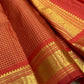 Close view of fine gold zari grid on Vermilion Red pure silk Kanchipuram saree.