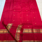 Vermilion Red Kanjeevaram saree body with small individual gold zari buttas.