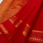 Close view of layered gold-zari geometric lines, floral bands and leaf-like edging on the red Rettapet border.