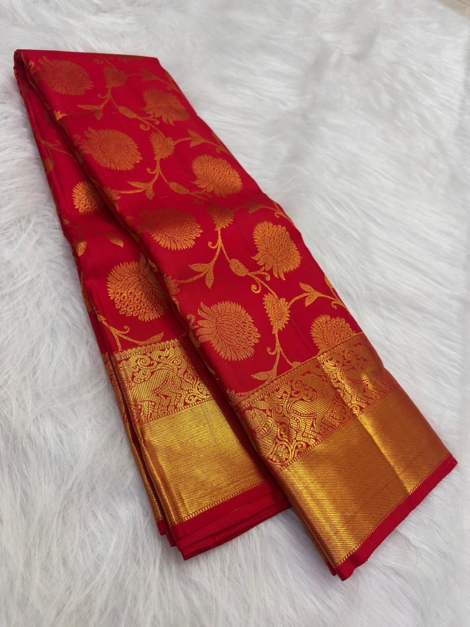 Vermilion red Kanjivaram saree with rich gold zari border and pallu