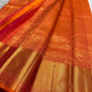 Close view of flying horse and floral zari motifs woven across the warm vermilion silk body.