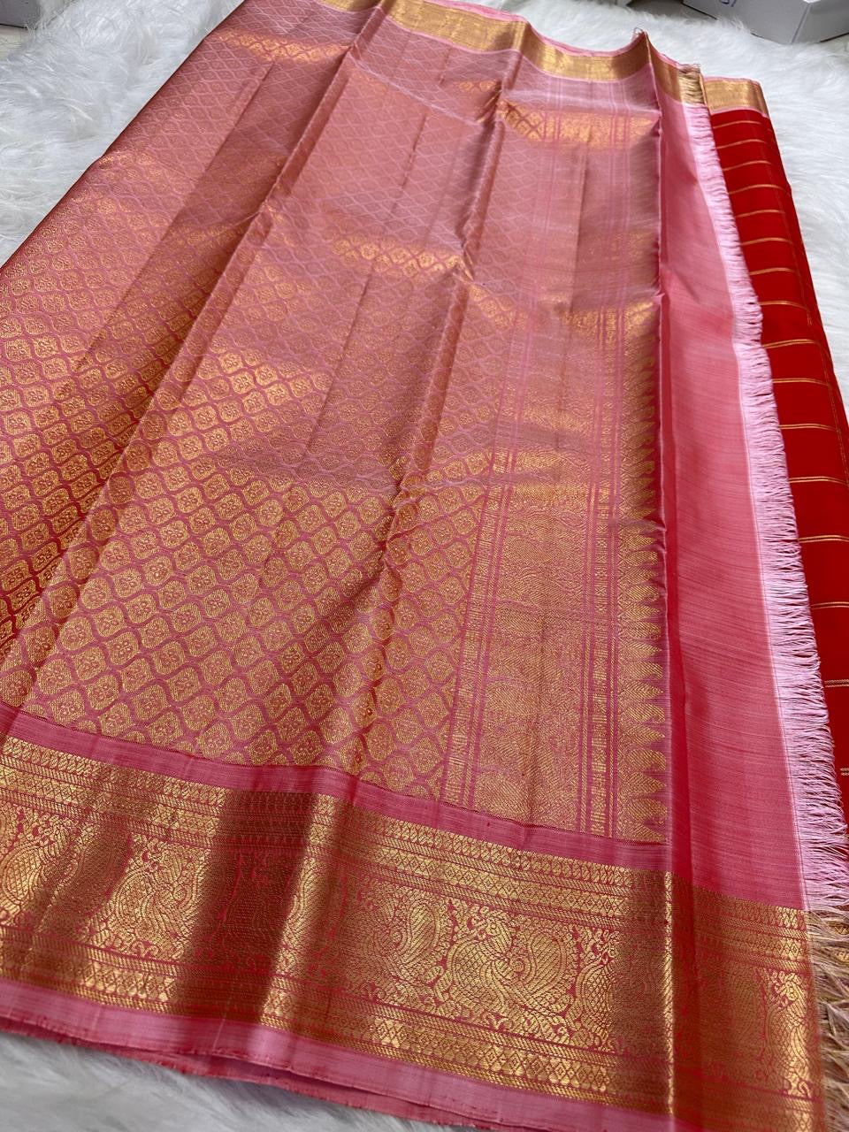 Fine gold Zari Kattam checks woven across the radiant Vermilion Red pure silk body.