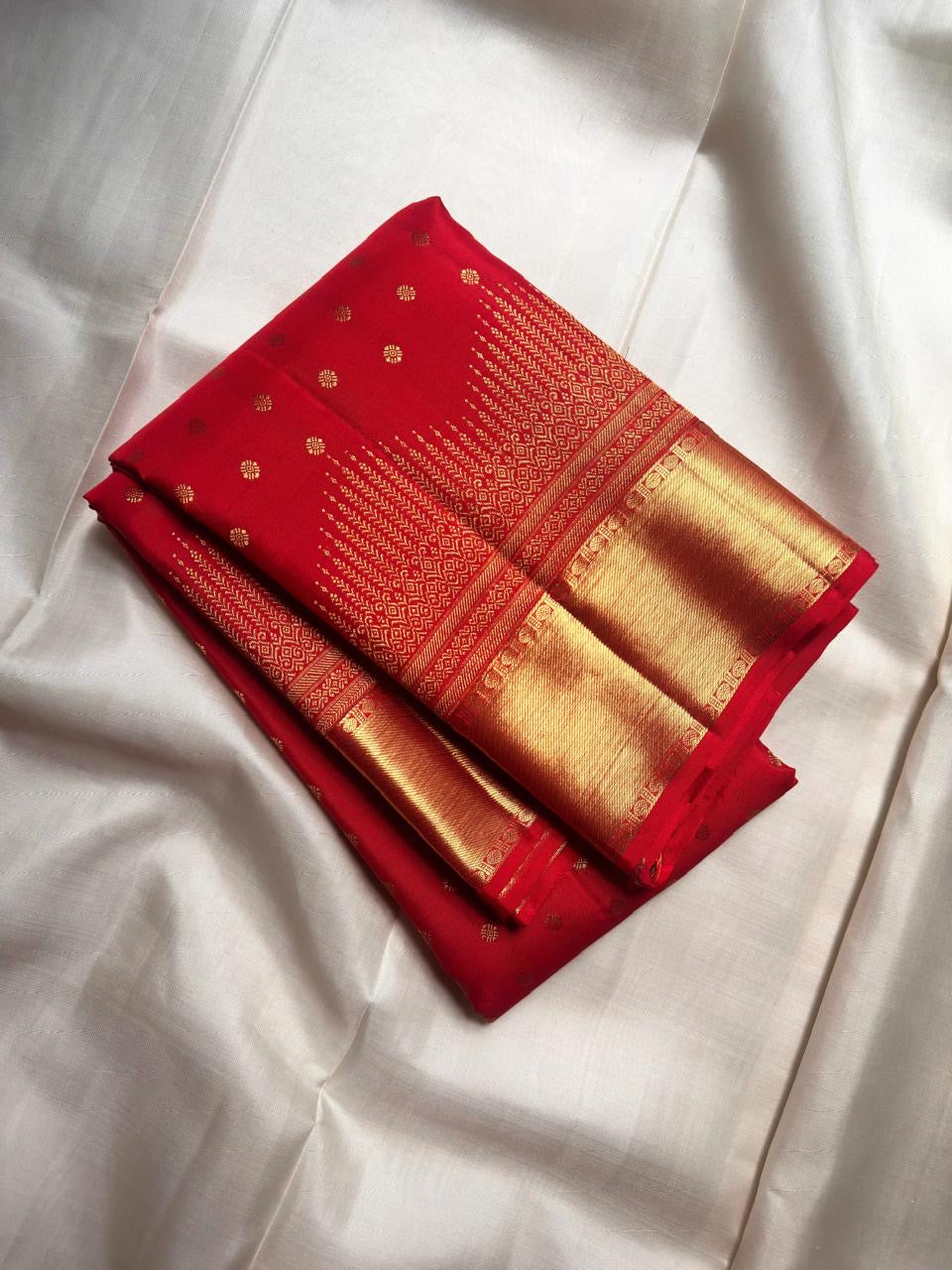 Handwoven Vermilion Red Kanchipuram silk saree with rows of petite gold zari motifs