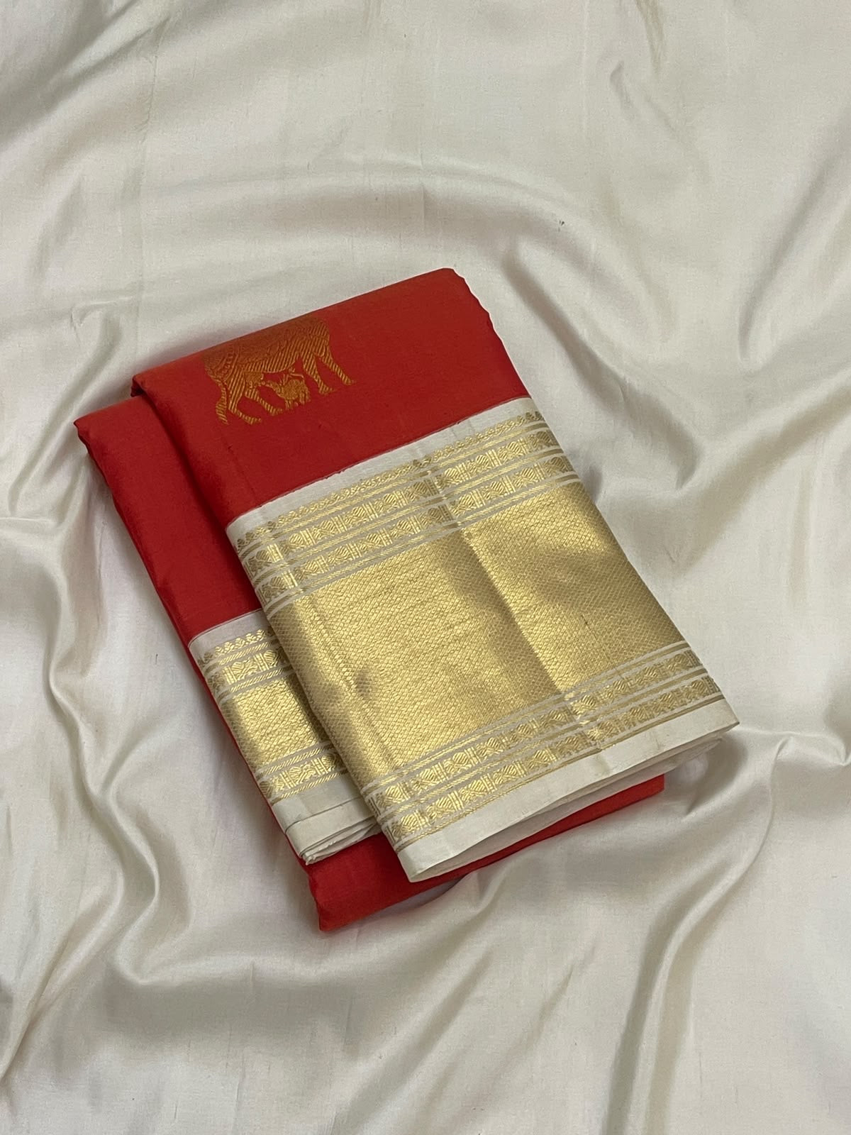 Vermilion Red Kanjivaram saree with large traditional cow zari buttas