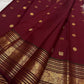 Deep red Kanchipuram silk with gold zari bands and an ornate border.