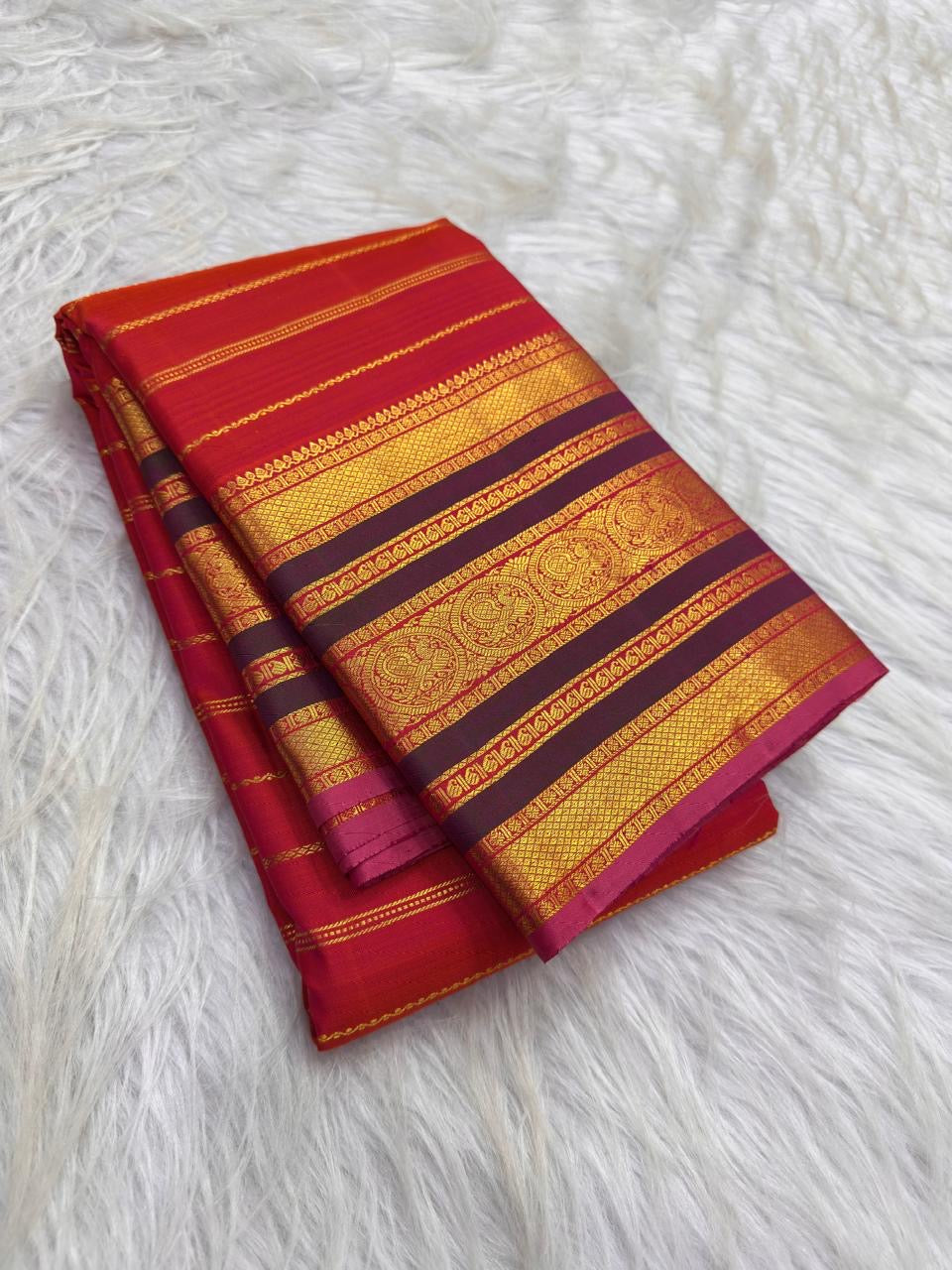 Handwoven red Kanchipuram silk with intricate Veldhari detailing.