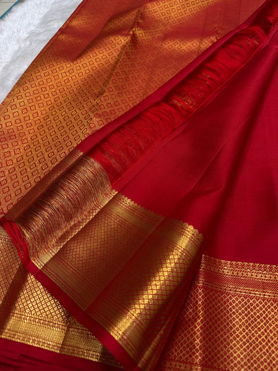 gold border detail of vermilion red Kanchipuram silk saree