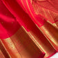 Vermilion Red handwoven Kanchipuram silk saree with small gold zari buttas and rich border.