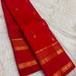 Vermilion-red Pure Silk Kanchipuram Rettapet saree with spaced gold-zari buttas and layered tonal border.