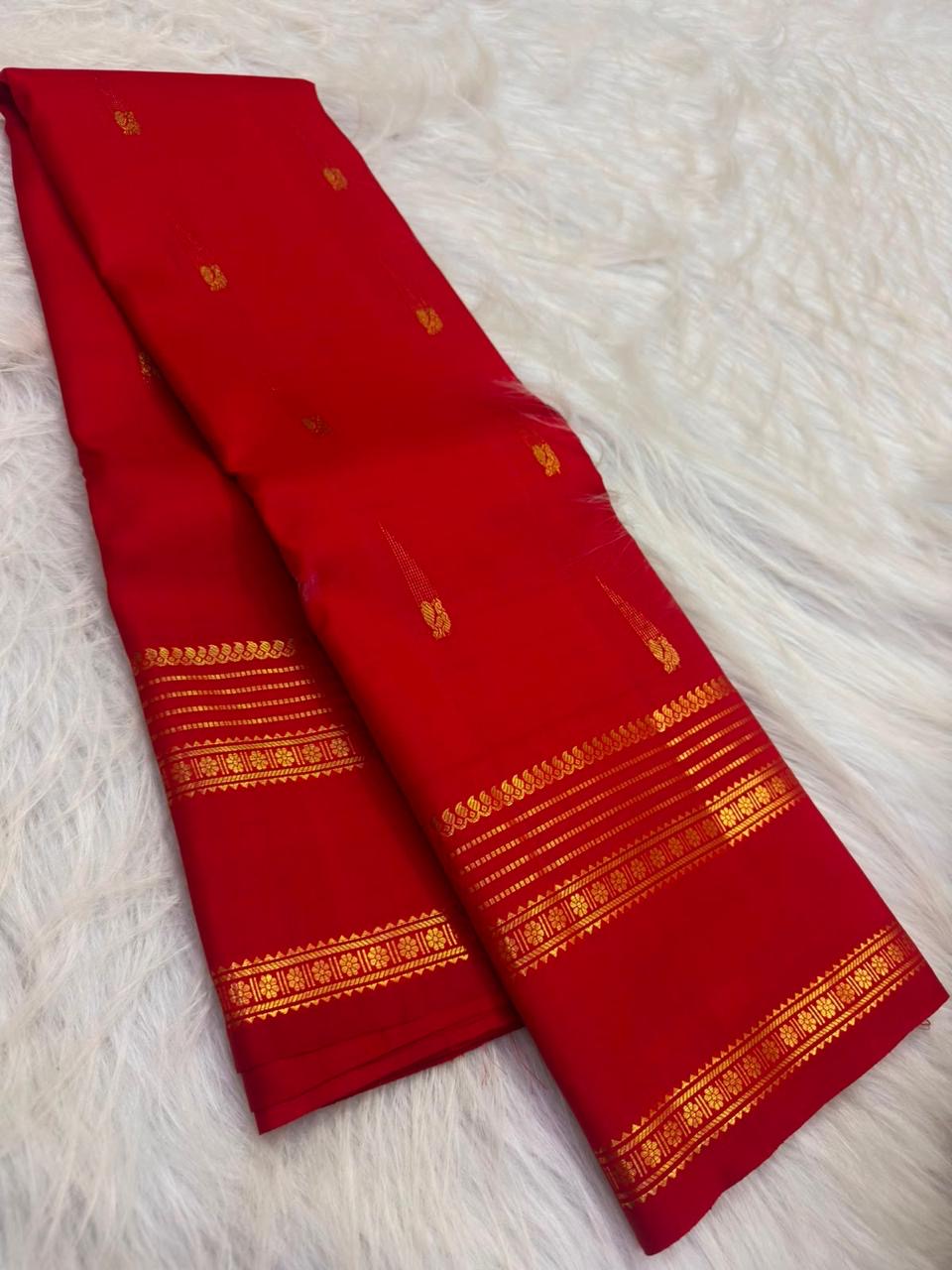 Vermilion-red Pure Silk Kanchipuram Rettapet saree with spaced gold-zari buttas and layered tonal border.
