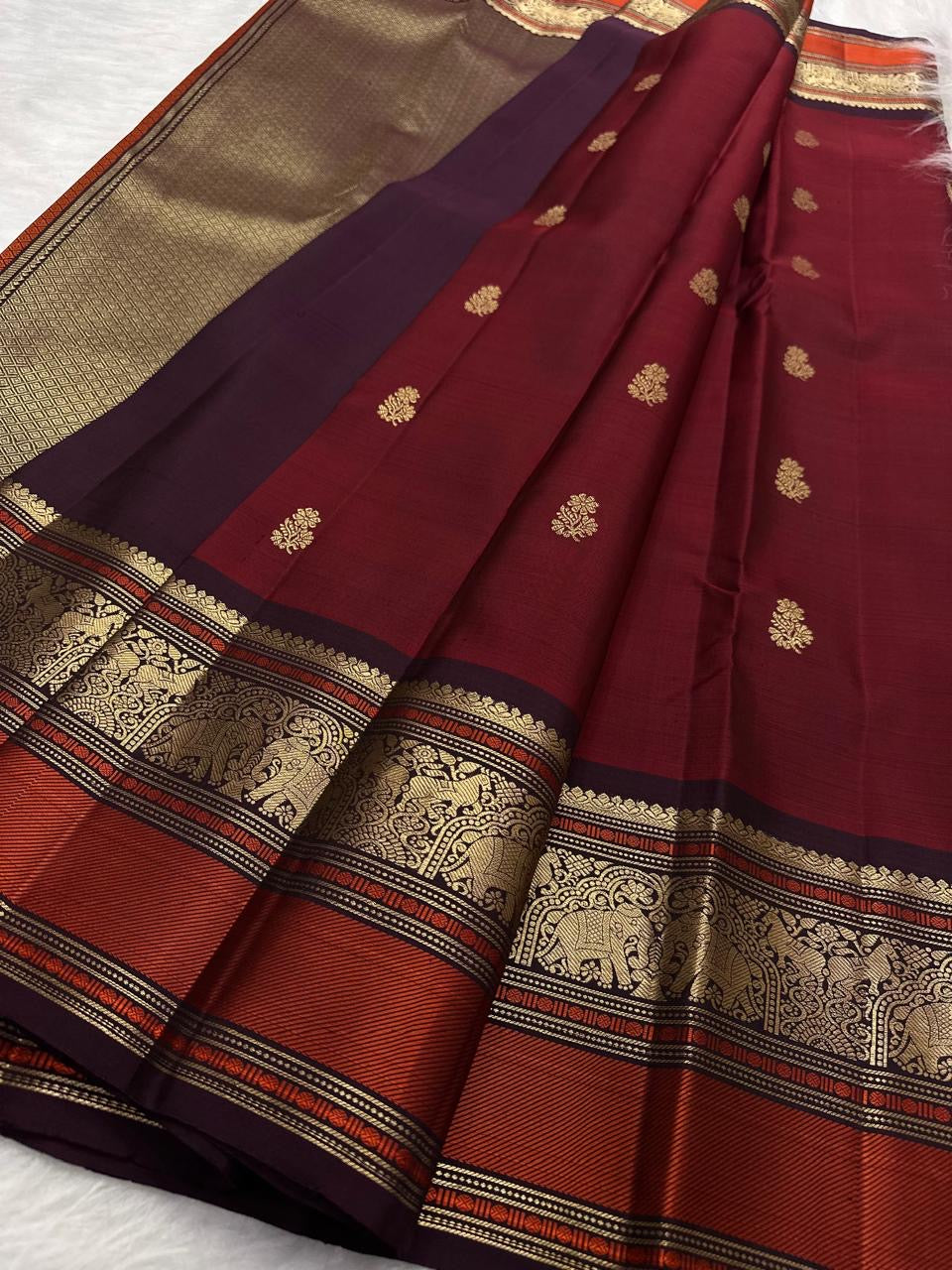 Vermilion Red pure silk Kanjivaram saree, Butta weave with Deep Aubergine border — folded view