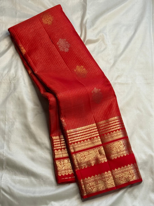 Full red Zari Kattam Kanchipuram saree showing structured grid body and ornate gold zari border.