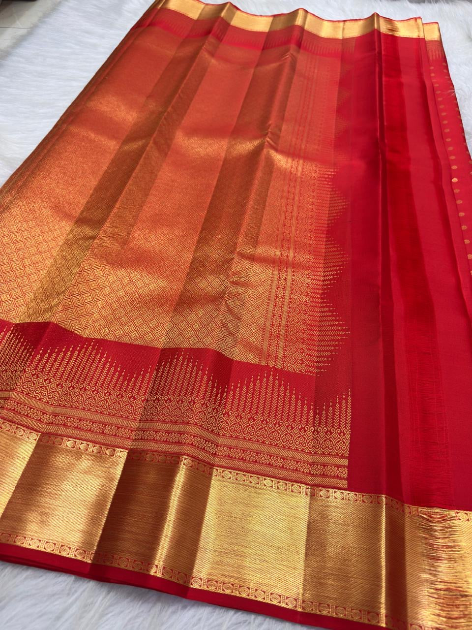 Vermilion Red Kanjivaram saree with intricate geometric antique gold zari border