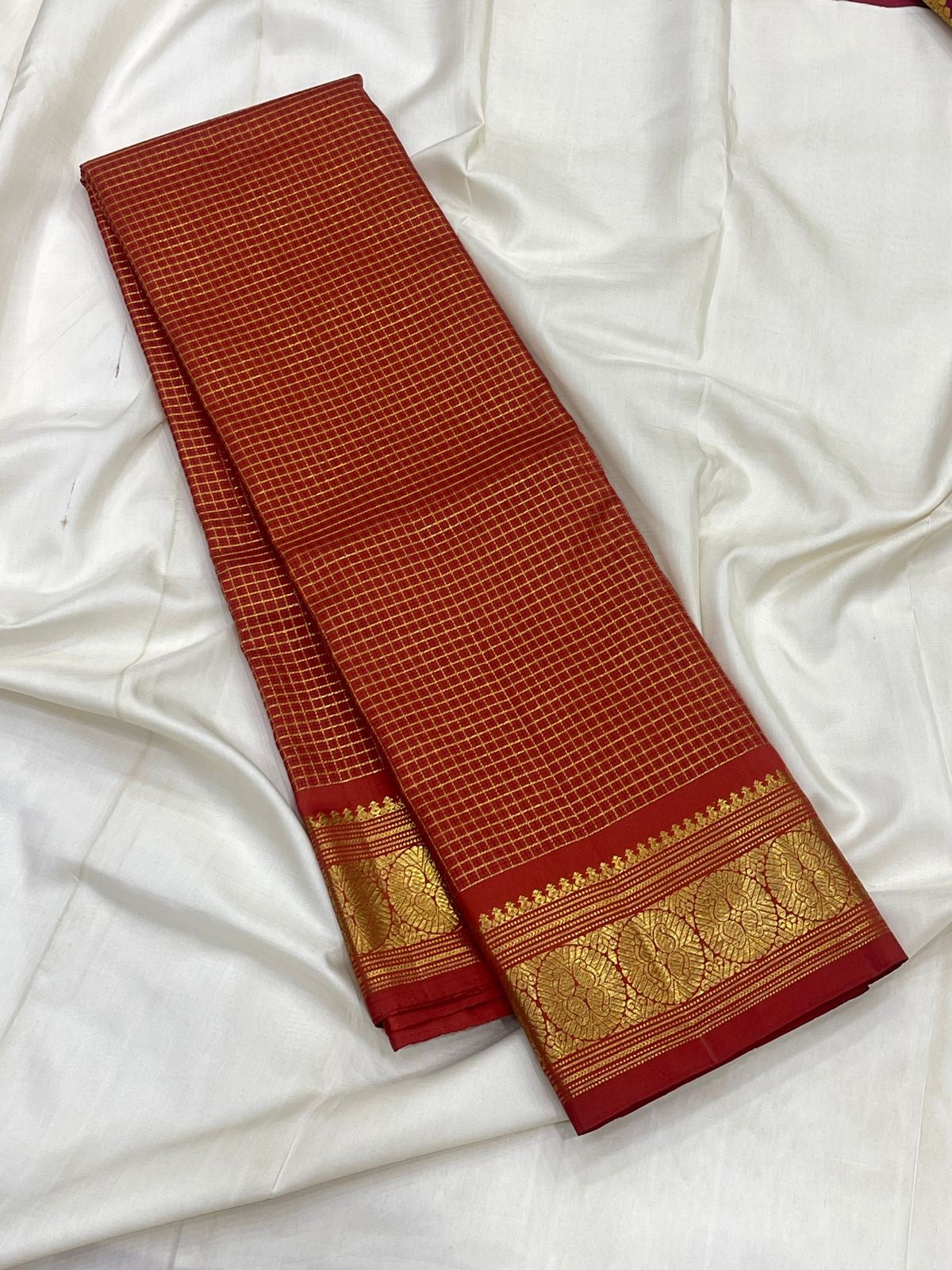 Vermilion Red Kanchipuram silk body woven with fine intersecting gold Zari Kattam checks.
