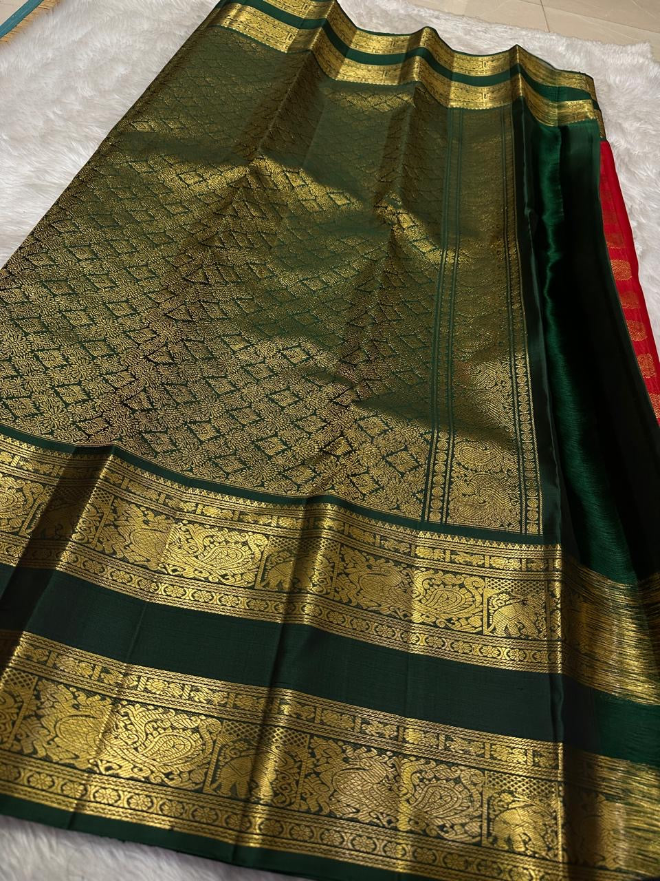 Full view of the vermilion red Rettapet silk saree with bottle green border