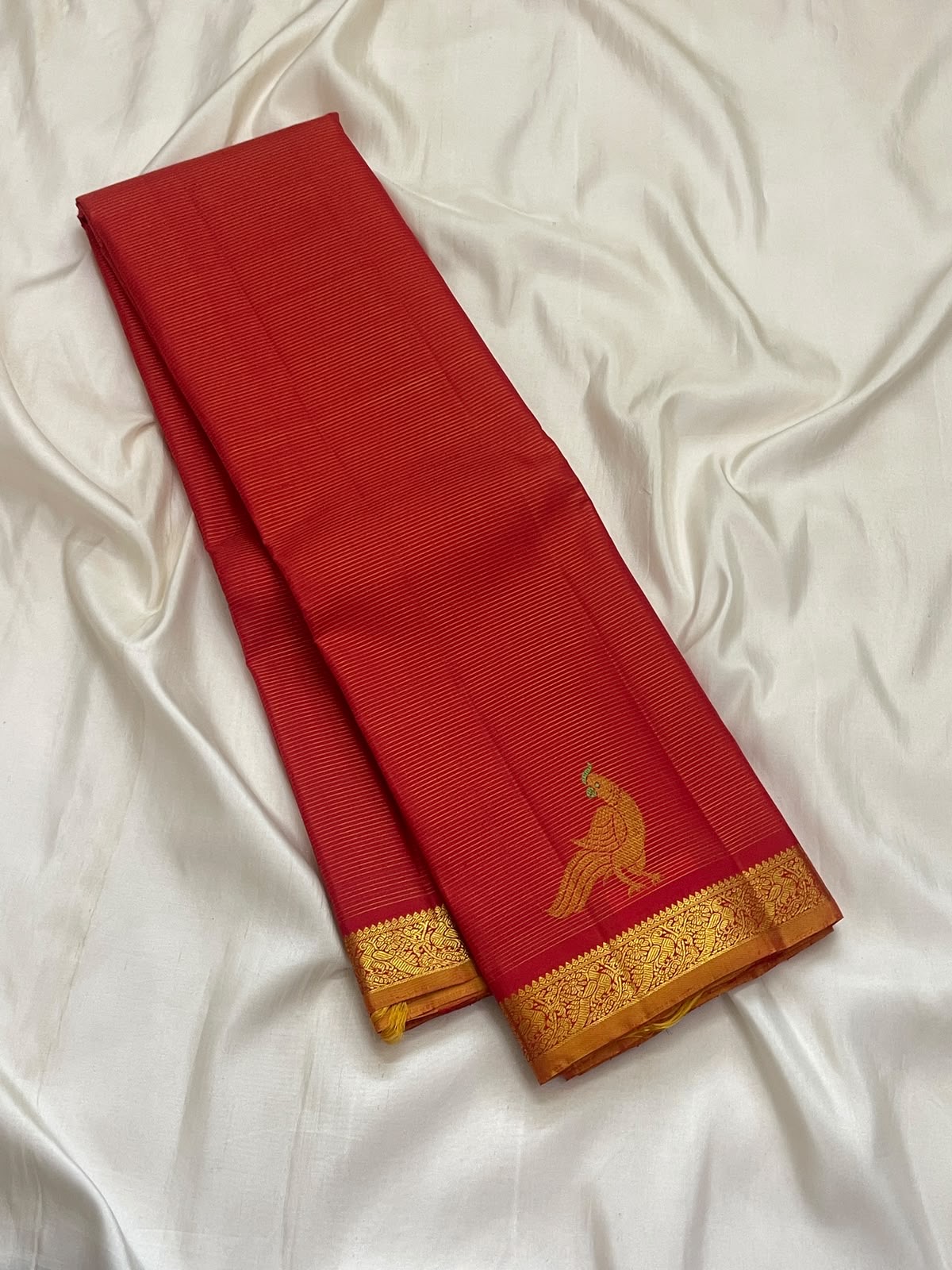 Vermilion red Vairaoosi Kanchipuram saree with Mayil zari motif, close-up