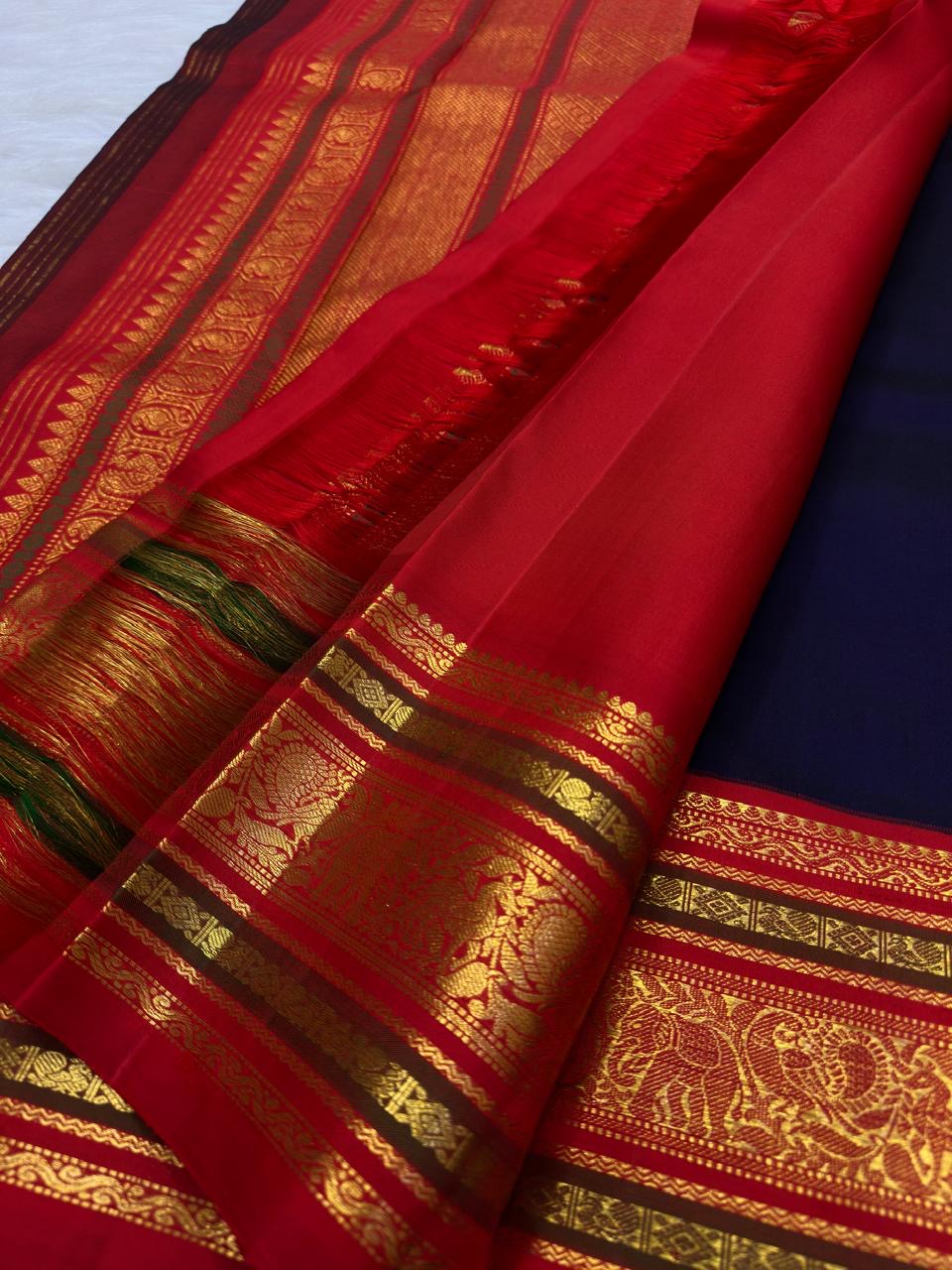 Vermilion Red and antique-gold multi-register Varisaipet border on deep navy pure silk.