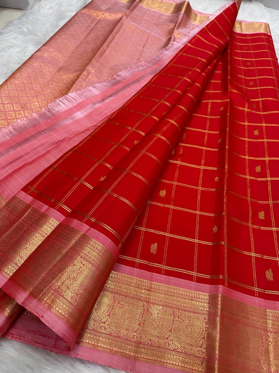 Tiny individual gold zari buttas positioned within the checked Vermilion Red Kanjeevaram body.