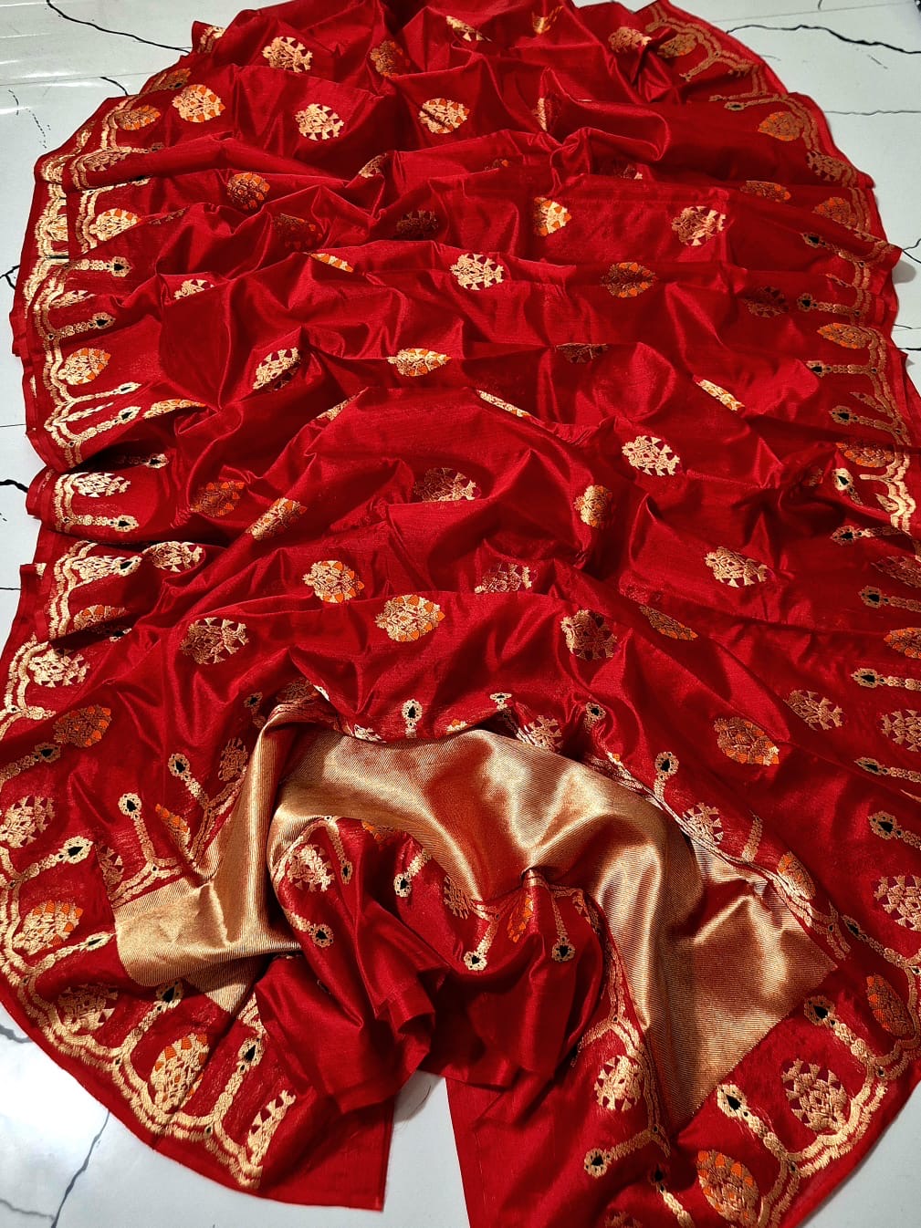 Close view of Vermillion Red Pattu Silk Chanderi saree with gold-toned motifs accented in orange and magenta