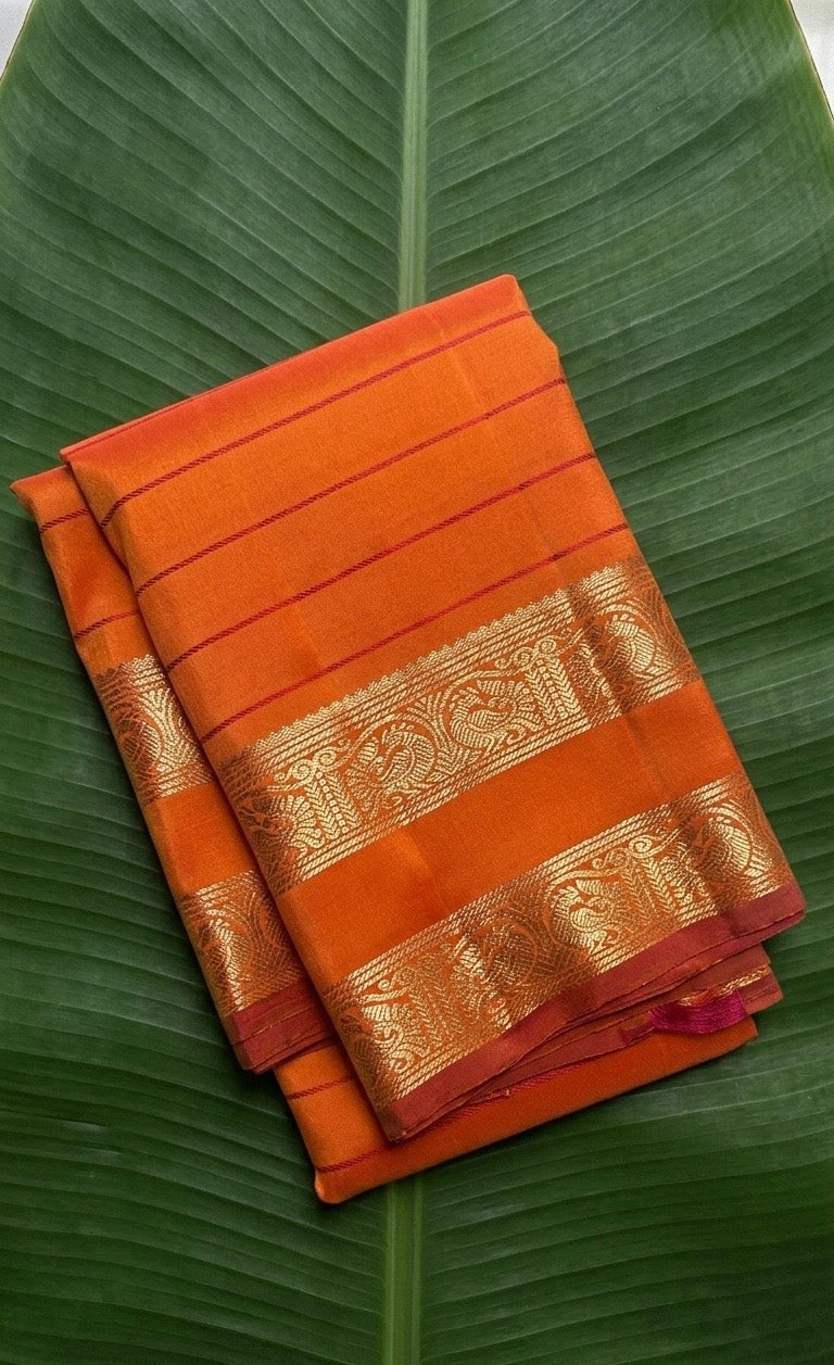 Kanchipuram silk saree in sunset orange with reddish pink border Veldhari Rettapet weave folded view