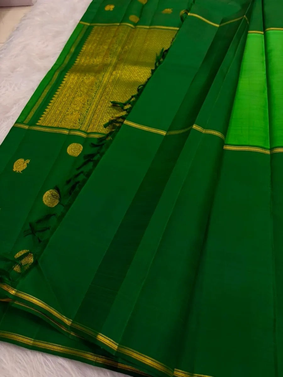 Vintage green pure silk Kanjivaram saree with restrained gold zari border and traditional motifs.