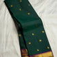 Zari detail close-up on deep emerald green Kanchipuram Butta saree