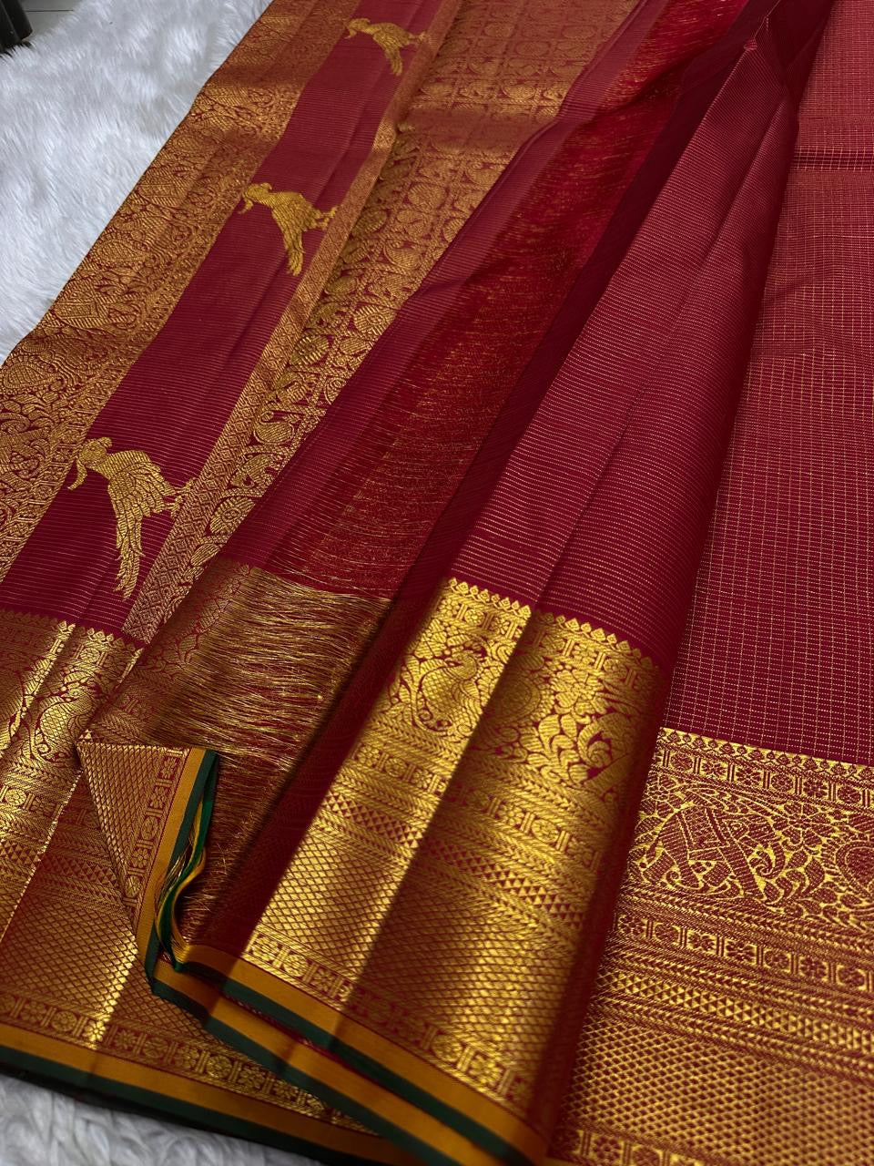 Vintage maroon Kancheepuram Zari Kattam silk saree, folded view with kili pallu.