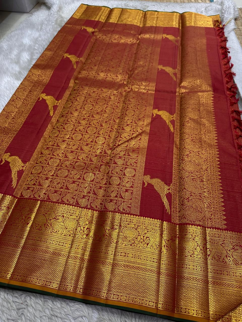 Vintage maroon Kanchipattu handwoven Zari Kattam saree with parrot motif detail.