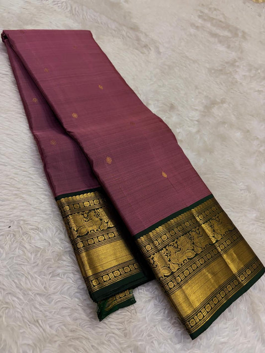 Vintage rose gold Kanchipuram silk saree with antique gold korvai and emerald border