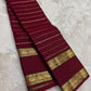 Deep red pure mulberry silk Kanchipuram saree with Veldhari zari and traditional gold buttas.