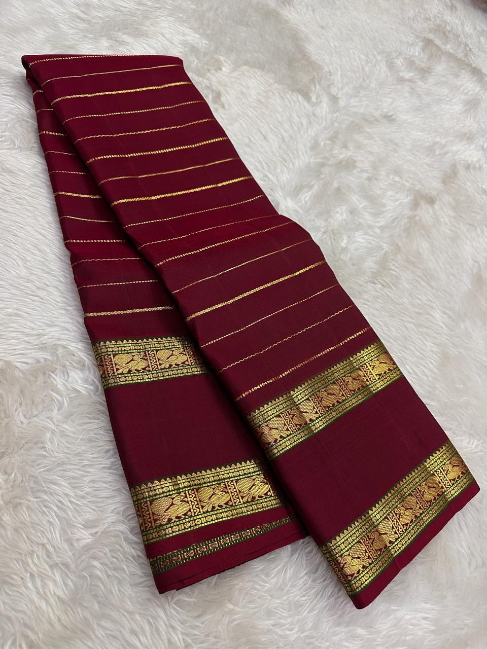 Deep red pure mulberry silk Kanchipuram saree with Veldhari zari and traditional gold buttas.