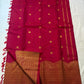 Full Red Deep Pink Kanchipuram Butta saree showing scattered gold zari motifs, broad Turning Border and coordinating blouse piece.