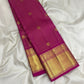 Rounded gold zari medallion butta woven into the Rani Pink Pure Silk body.