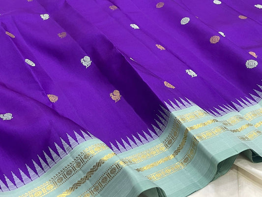 Royal violet blue Kanjeevaram silk saree body close-up showing Mayil Chakram circular peacock medallion buttas in silver zari