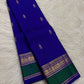Vivid Neelam Blue and Emerald Green pure silk Kanchipuram Varisaipet saree, full saree folded for display.