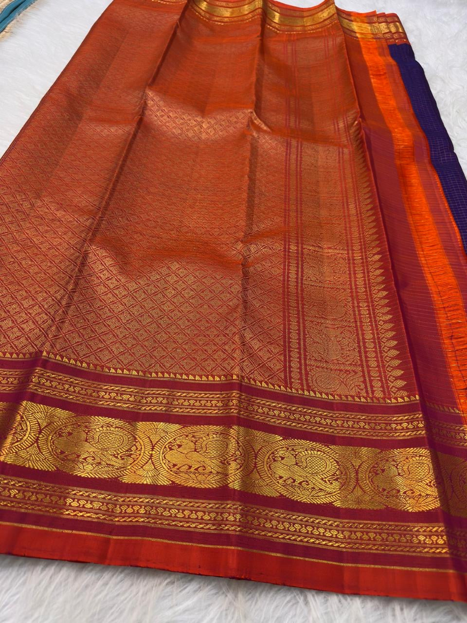 Fine gold Zari Kattam checks and buttas across the deep violet silk body