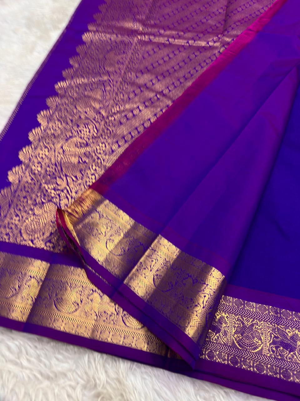 Purple silk saree with traditional zari peacock border and rich festive drape