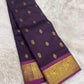 Imperial violet silk saree with classic gold zari motifs and peacock border